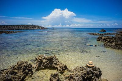 Scenic view of sea against cloudy sky