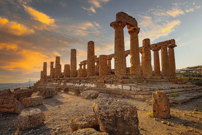 Abandoned temple against sky during sunset