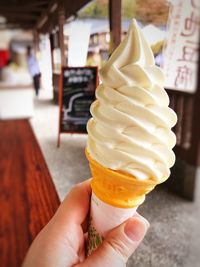 Cropped image of hand holding ice cream cone