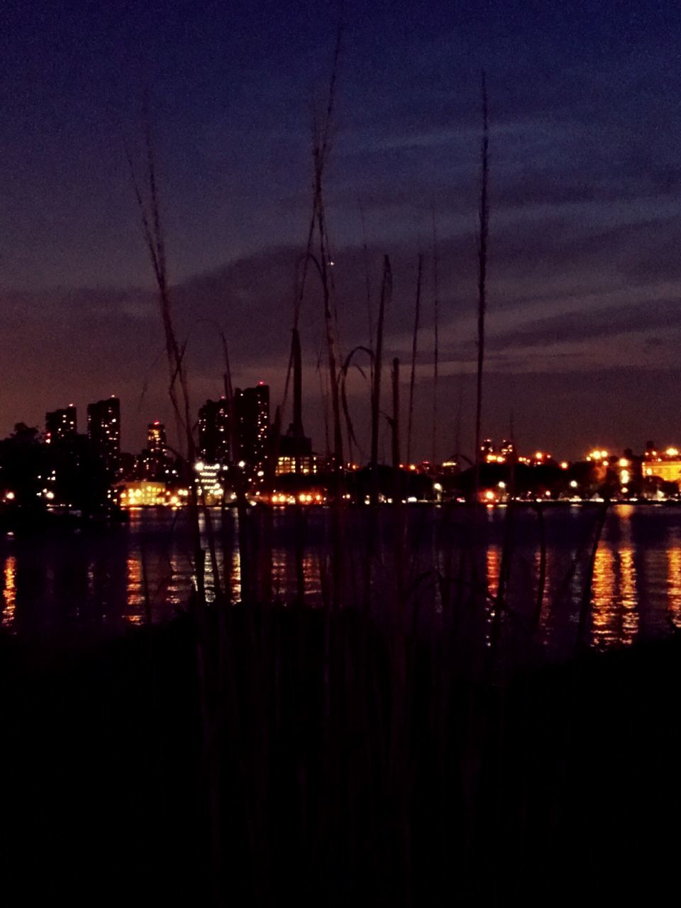 illuminated, night, water, city, building exterior, sky, cityscape, reflection, waterfront, built structure, architecture, river, sea, lake, dusk, outdoors, no people, cloud - sky, harbor, scenics