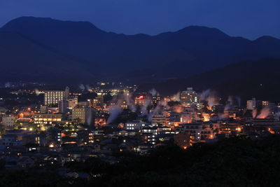 High angle view of illuminated buildings in city at night