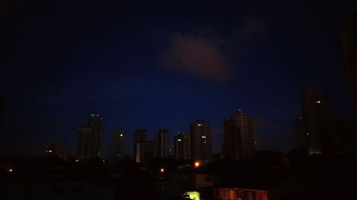 Illuminated cityscape against sky at night