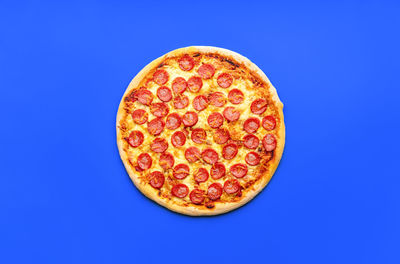 Directly above shot of pizza on blue background