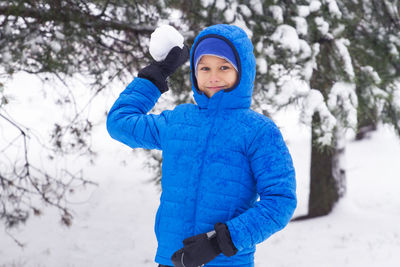 Portrait of smiling boy holding snow
