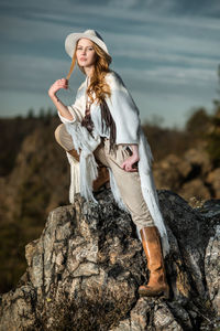 Portrait of fashionable woman standing on rock