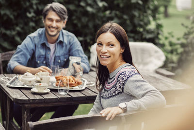 Portrait of happy couple having breakfast at organic farm