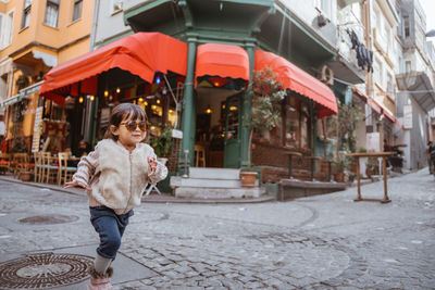 Portrait of woman standing on street