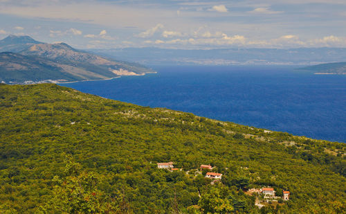 Scenic view of landscape and sea against sky