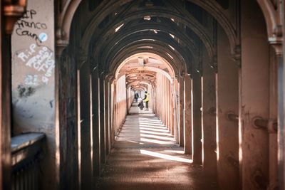 People walking in corridor of building