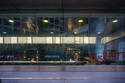 Reflection of illuminated buildings on glass window at night