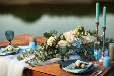 Festive table in blue tones on the banks of the river