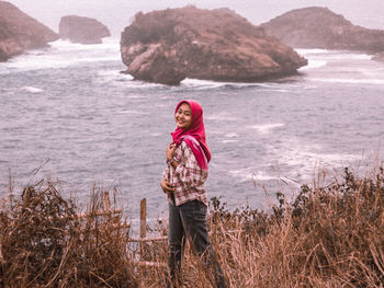 Portrait of smiling standing on shore