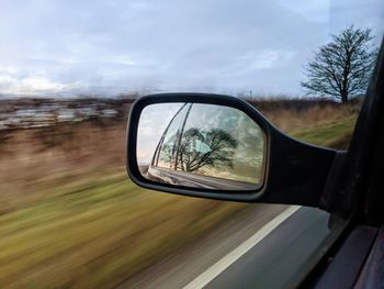 Reflection of car on side-view mirror