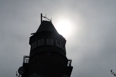 Low angle view of silhouette building against sky