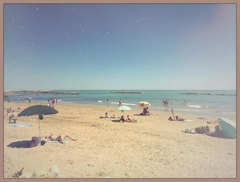 Scenic view of beach against blue sky