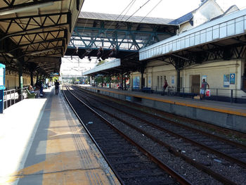 People waiting at railroad station platform