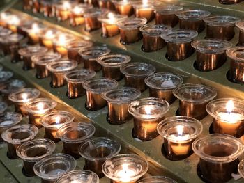 Rows of candles inside of the milan cathedral milan