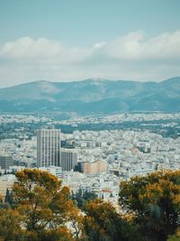 Photo of urban athens with hills in the distance 