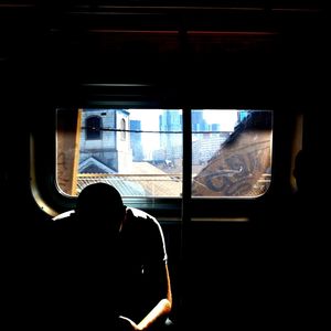 Woman looking through window