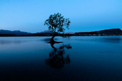 Scenic view of lake against clear blue sky