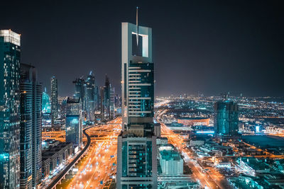 High angle view of city lit up at night