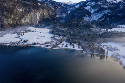 Scenic view of lake and snowcapped mountains during winter