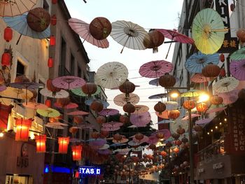 Low angle view of illuminated lanterns hanging in city