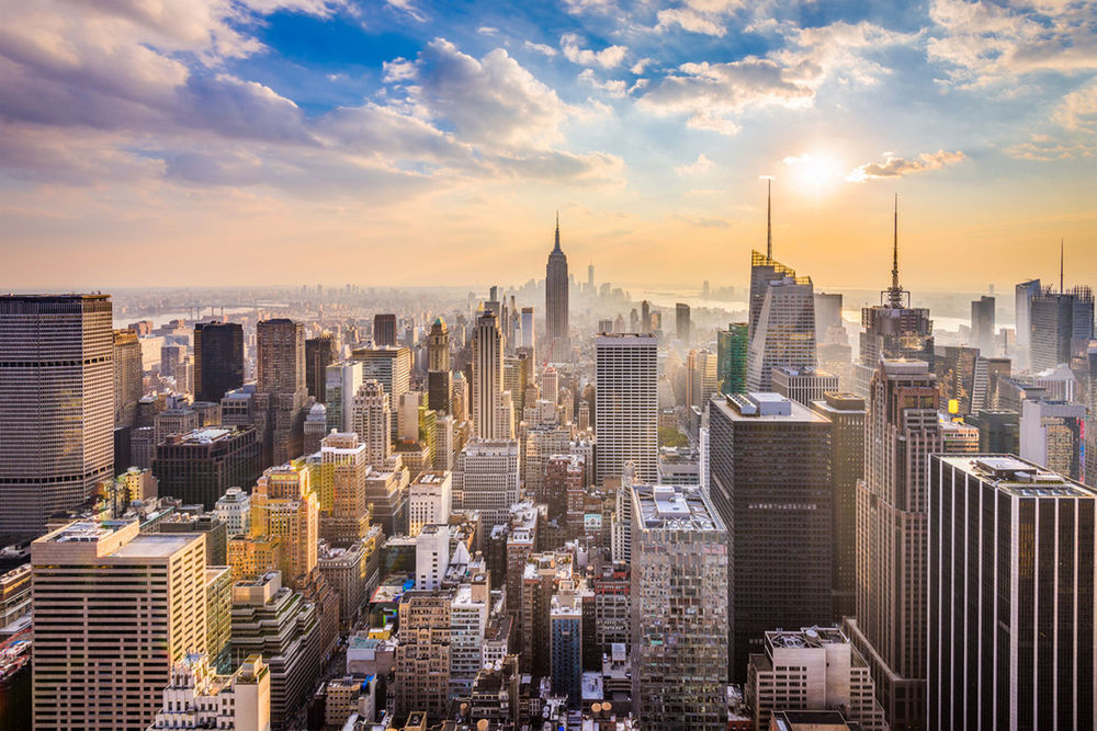 AERIAL VIEW OF BUILDINGS AGAINST CLOUDY SKY