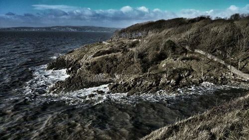 Scenic view of sea against cloudy sky