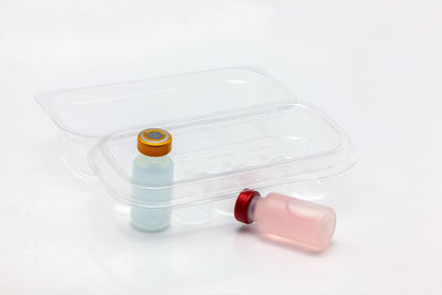 High angle view of bottle on table against white background