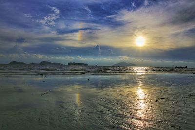 Scenic view of beach against sky during sunset