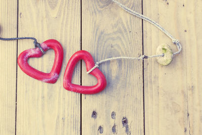 Close-up of red hanging on wood