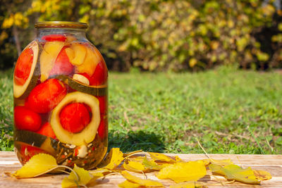 Close-up of fruits in glass jar on table