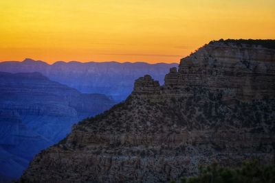 Scenic view of mountains against sky at sunset