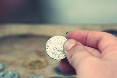 Close-up of hand holding coins