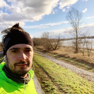 Portrait of young man with road against sky