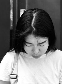 Close-up portrait of young woman looking down