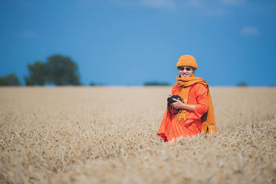 Midsection of woman standing on field