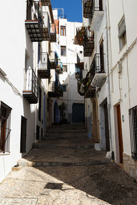 Empty alley amidst buildings in town