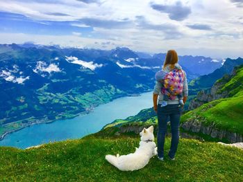 Rear view of woman looking at mountain against sky