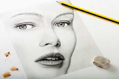 Close-up portrait of young woman against white background
