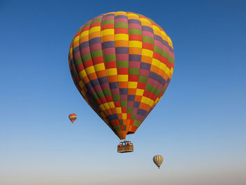 Low angle view of hot air balloons against clear sky