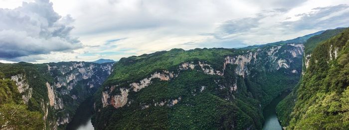 Scenic view of mountains against cloudy sky