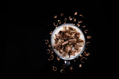 High angle view of coffee cup against black background