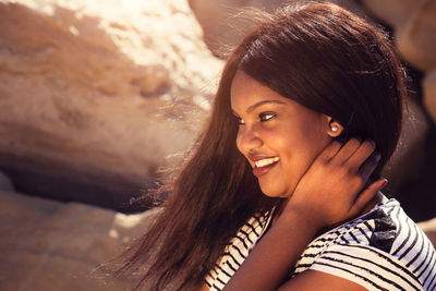 Portrait of smiling young woman looking away