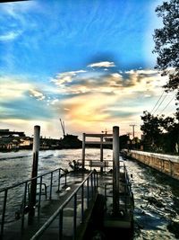 Pier on sea at sunset