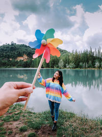 Cropped hand of woman holding small toy