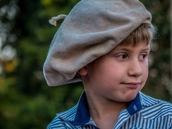Close-up of thoughtful boy wearing flat cap