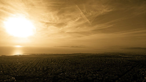 Scenic view of field against sky during sunset