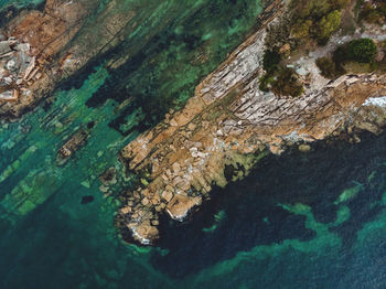 High angle view of rock formations by sea